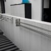 2 Ez CLC wall rack outdoors: one in open mode and the other in closed position. Stainless Steel. Heavy-duty.
