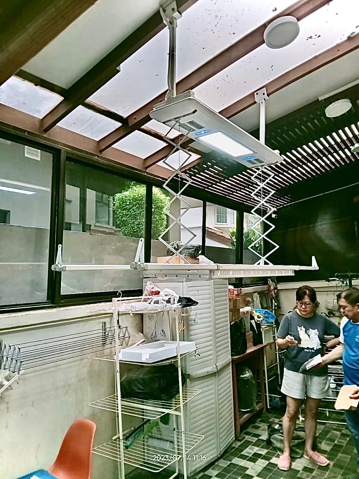 A sloping roof yet custom bracketing is designed to mount the automated laundry drying system in this landed property.